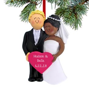 Bride and Groom Holding A Pink Heart Ornament